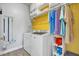 Laundry room featuring a washer, dryer, and storage shelves with white cabinetry at 144 Back Tee Cir, Summerville, SC 29485