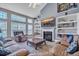Comfortable living room with fireplace, bookshelves and natural light at 144 Back Tee Cir, Summerville, SC 29485
