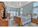 Comfortable main bedroom features a tray ceiling, ceiling fan, and warm natural light at 144 Back Tee Cir, Summerville, SC 29485