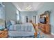Comfortable main bedroom features a tray ceiling, ceiling fan, and warm natural light at 144 Back Tee Cir, Summerville, SC 29485