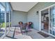 Screened porch with wicker chairs, an outdoor ceiling fan, and views of the backyard at 144 Back Tee Cir, Summerville, SC 29485