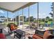 Relaxing screened porch with ample seating and views of the surrounding yard and neighborhood at 144 Back Tee Cir, Summerville, SC 29485