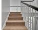 Carpeted staircase with white railing provides seamless transition between floors at 144 Back Tee Cir, Summerville, SC 29485