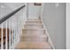 Carpeted staircase with white railing provides seamless transition between floors at 144 Back Tee Cir, Summerville, SC 29485