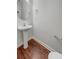Cozy half bath featuring a pedestal sink, modern fixtures, and hardwood-style flooring at 159 Antebellum Way, Summerville, SC 29483