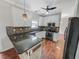 Well-appointed kitchen with granite counters, white cabinets, black appliances, and mosaic backsplash at 159 Antebellum Way, Summerville, SC 29483