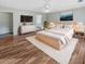 Bright primary bedroom with modern furniture, hardwood floors, a ceiling fan, and a walk-in closet at 159 Antebellum Way, Summerville, SC 29483