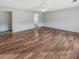 Empty primary bedroom featuring wood floors, ceiling fan, walk-in closet, and an ensuite bathroom at 159 Antebellum Way, Summerville, SC 29483