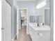 Bright bathroom featuring a vanity with a large mirror and a view into the kitchen at 1600 Long Grove Dr # 626, Mount Pleasant, SC 29464
