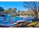 Community pool area with lounge chairs, umbrellas, and a view of the clubhouse at 1600 Long Grove Dr # 626, Mount Pleasant, SC 29464