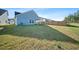 Picture of home's backyard with grass, privacy fence, and light blue siding on the house at 173 Paddle Boat Way, Summerville, SC 29485