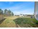 Backyard view featuring a large grassy area extending from the house to a line of tall trees at 173 Paddle Boat Way, Summerville, SC 29485