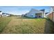 Exterior yard view with a large grassy area and neighboring houses in the distance at 173 Paddle Boat Way, Summerville, SC 29485