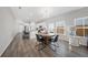 Open-concept dining area with a view into the kitchen, bright natural light, and modern furnishings at 173 Paddle Boat Way, Summerville, SC 29485