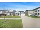 Charming light blue home with a well-manicured lawn and long driveway leading to a one car garage at 173 Paddle Boat Way, Summerville, SC 29485