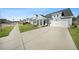Inviting light blue home with a covered porch, a long driveway, and curb appeal at 173 Paddle Boat Way, Summerville, SC 29485