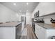 Bright kitchen with white cabinets, stainless steel appliances, granite countertops, and modern flooring at 173 Paddle Boat Way, Summerville, SC 29485