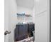 Functional laundry area with modern washer and dryer units and overhead storage shelves at 173 Paddle Boat Way, Summerville, SC 29485