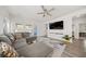 Cozy living room with a large gray sectional, modern ceiling fan, and a stylish patterned rug at 173 Paddle Boat Way, Summerville, SC 29485