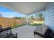 Outdoor covered patio with neutral colored furniture overlooking a spacious backyard at 173 Paddle Boat Way, Summerville, SC 29485