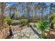 Inviting backyard patio with stone pavers, a gas grill, lush landscaping, and a pond with fountain at 1807 Chauncy'S Ct, Mount Pleasant, SC 29466