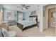 A bright bedroom with blue walls, a ceiling fan, and large windows for plenty of light at 1807 Chauncy'S Ct, Mount Pleasant, SC 29466