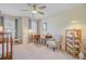 This bedroom features neutral walls, carpet, a ceiling fan, two windows and a chair at 1807 Chauncy'S Ct, Mount Pleasant, SC 29466