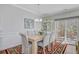 Traditional dining room with stylish rug, wainscotting, chandelier, and access to screened in porch at 1807 Chauncy'S Ct, Mount Pleasant, SC 29466