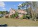 Charming two-story home boasts a spacious lawn, mature trees, and a screened-in porch for outdoor relaxation at 1807 Chauncy'S Ct, Mount Pleasant, SC 29466