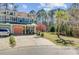 Attractive townhouse with well-maintained lawn, a driveway, and lush trees and landscaping at 1807 Chauncy'S Ct, Mount Pleasant, SC 29466