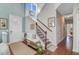 Welcoming two-story foyer with hardwood floors, staircase, bench, and natural light at 1807 Chauncy'S Ct, Mount Pleasant, SC 29466