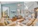 Comfortable and stylish living room with high ceilings, large windows, and a calming color palette at 1807 Chauncy'S Ct, Mount Pleasant, SC 29466