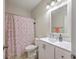 Well-lit bathroom featuring a shower with curtain and white vanity at 1822 Chatelain Way, Mount Pleasant, SC 29464