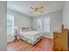 Well-lit bedroom with wood floors, ceiling fan and natural light from the windows at 1822 Chatelain Way, Mount Pleasant, SC 29464