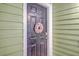 Charming black front door with a seashell wreath and a coded lock system at 1822 Chatelain Way, Mount Pleasant, SC 29464