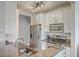 Well-equipped kitchen with stainless steel appliances, stone countertops, and white cabinets at 1822 Chatelain Way, Mount Pleasant, SC 29464