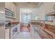 Well-lit kitchen with granite countertops, stainless steel appliances, and an open view to the dining area at 1822 Chatelain Way, Mount Pleasant, SC 29464