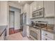 Modern kitchen boasts stainless steel appliances, white cabinetry, and eat-in counter at 1822 Chatelain Way, Mount Pleasant, SC 29464