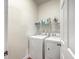 Bright laundry room features a washer, dryer, and a shelf for storage at 1822 Chatelain Way, Mount Pleasant, SC 29464