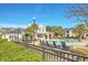 Exterior view of the community pool with lounge chairs, tropical landscaping, and nearby buildings on a sunny day at 1822 Chatelain Way, Mount Pleasant, SC 29464