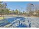Outdoor tennis court on a sunny day surrounded by trees; a great recreational amenity for residents at 1822 Chatelain Way, Mount Pleasant, SC 29464