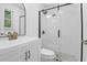Modern bathroom features white vanity with brass fixtures and an enclosed glass shower with black hardware at 1873 Hazelwood Dr, Charleston, SC 29407