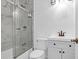 Elegant bathroom featuring a glass-enclosed shower, white vanity, and marble-patterned tile at 1873 Hazelwood Dr, Charleston, SC 29407