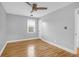 Bedroom featuring hardwood floors, two windows, fresh paint, and a ceiling fan at 1873 Hazelwood Dr, Charleston, SC 29407