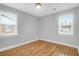 Bedroom featuring hardwood floors, two windows, and a neutral color scheme at 1873 Hazelwood Dr, Charleston, SC 29407