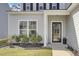 Inviting front entrance featuring a modern glass door, manicured landscaping, and home address at 203 Hayworth Rd, Summerville, SC 29486