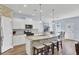 Bright kitchen features white cabinets, granite countertops, stainless steel appliances and a spacious center island with seating at 203 Hayworth Rd, Summerville, SC 29486