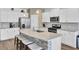 Bright kitchen features white cabinets, granite countertops, stainless steel appliances and a spacious center island with seating at 203 Hayworth Rd, Summerville, SC 29486