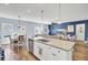 Bright kitchen features white cabinets, granite countertops, stainless steel appliances and a spacious center island with seating at 203 Hayworth Rd, Summerville, SC 29486