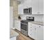 Bright kitchen features white cabinets, granite countertops, stainless steel appliances and a center island at 203 Hayworth Rd, Summerville, SC 29486
